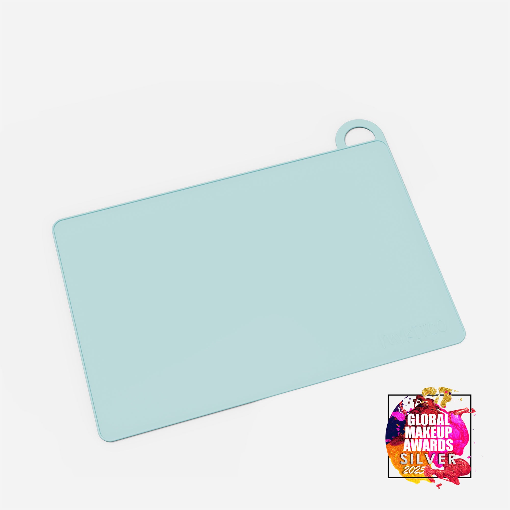 Blue MY BIG MAKEUP MAT by MYKITCO, a makeup tools mat with awards, shown in the image.