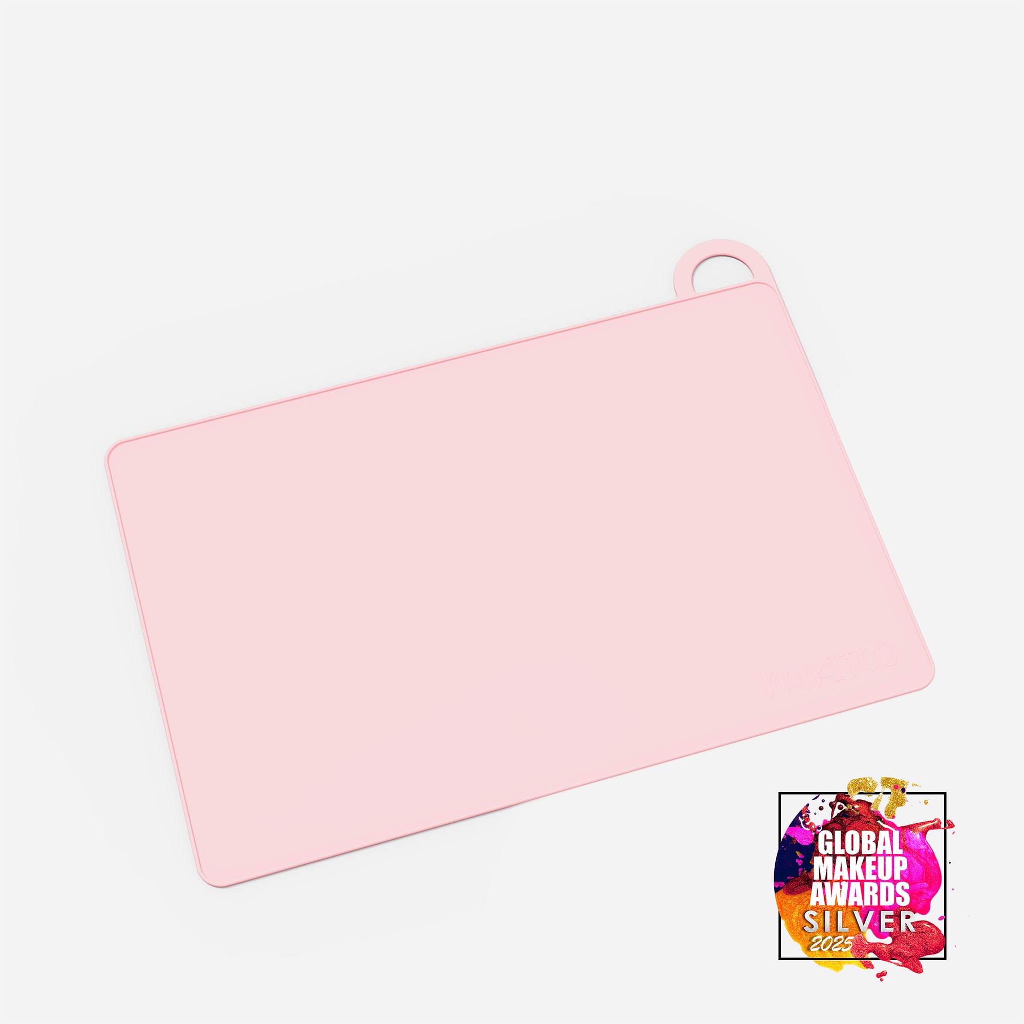 Pink MY BIG MAKEUP MAT by MYKITCO, a versatile makeup tools mat with an award badge, used for makeup application and organization.